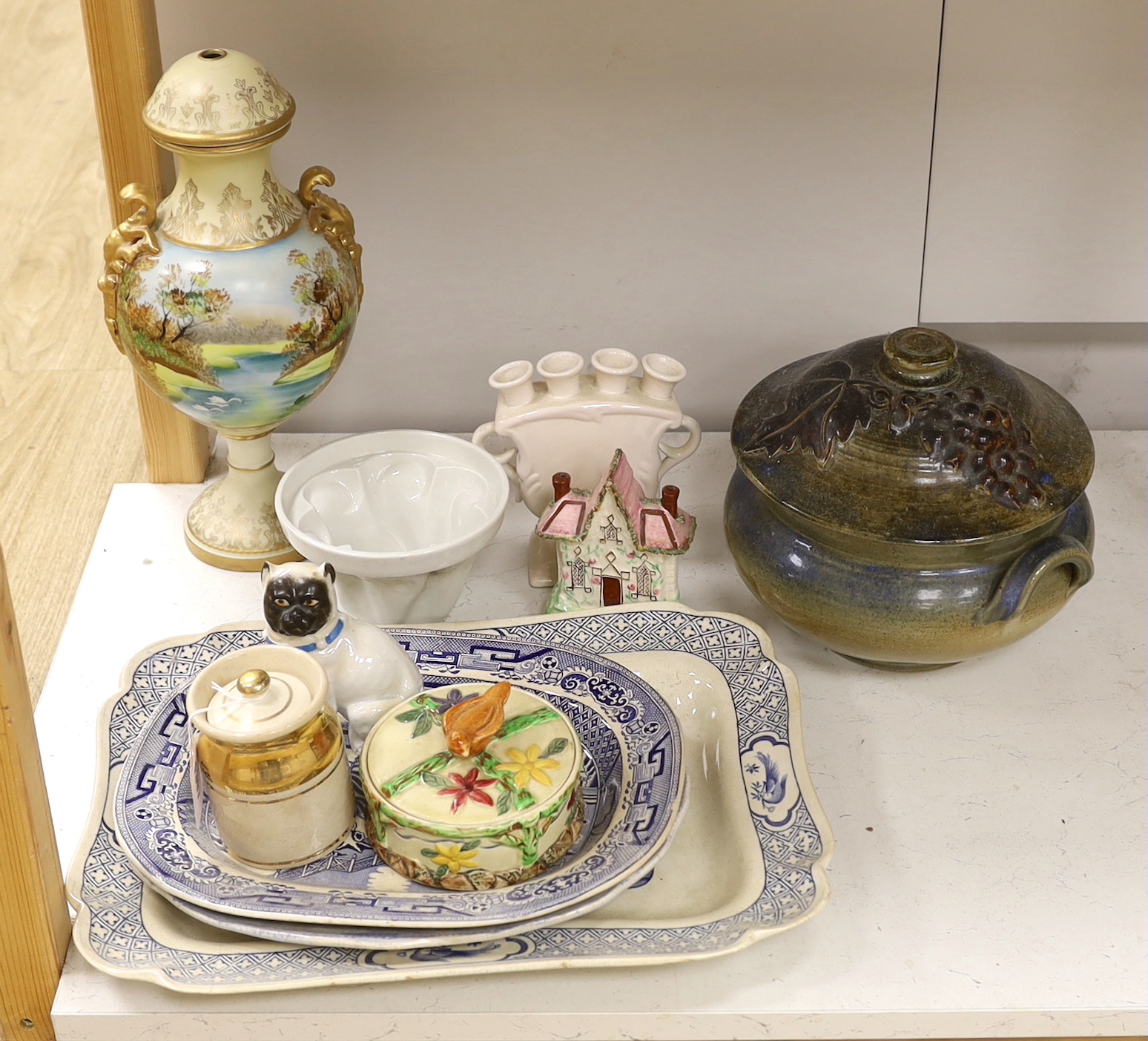 A large pottery tureen and cover, a large centrepiece and mixed ceramics including meat platters